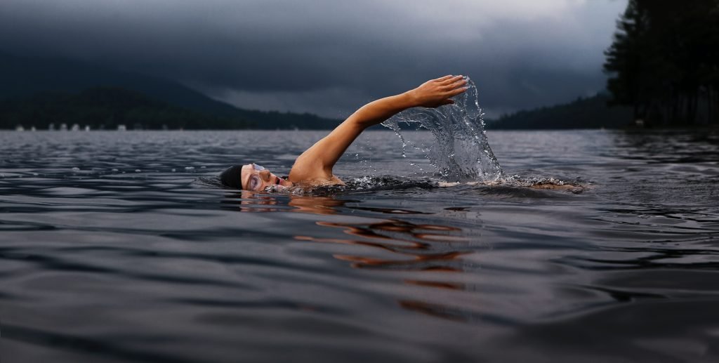 Mensch schwimmt im Wasser.