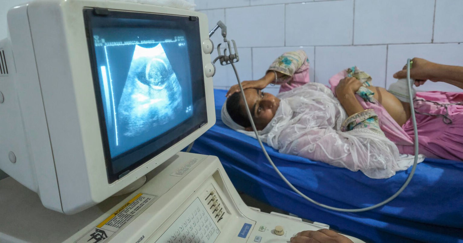 5 month Pregnant Akhtar Be (21) getting her Ultrasonography done by Dr.Sudheshwar Kumar (51) Medical Officer in Community Health Centre, Surnakote Jammu India. India newborn action plan (INAP) midterm review