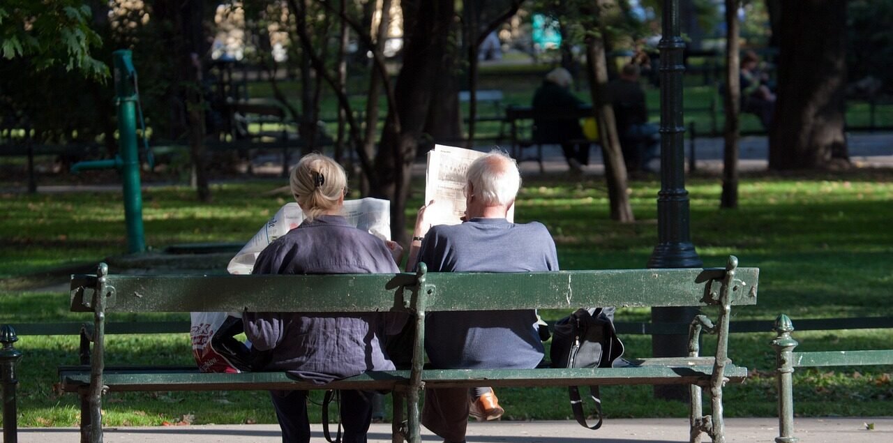 Pärchen, das auf einer Parkbank im Stadtpark sitzt